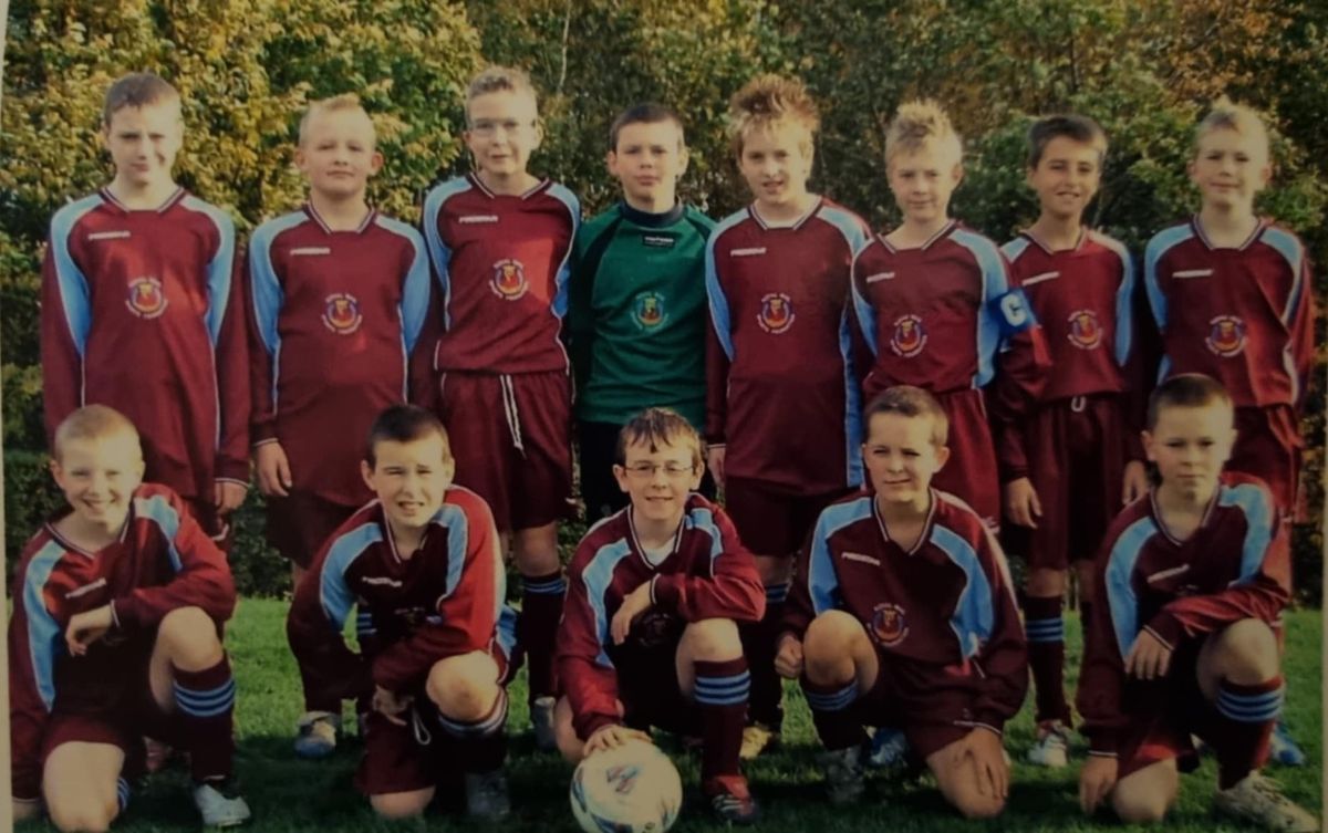 Our Woodhouse Junior F.C. team aged around 11 and 12, in claret and sky blue kits, with the captain's armband and a match ball
